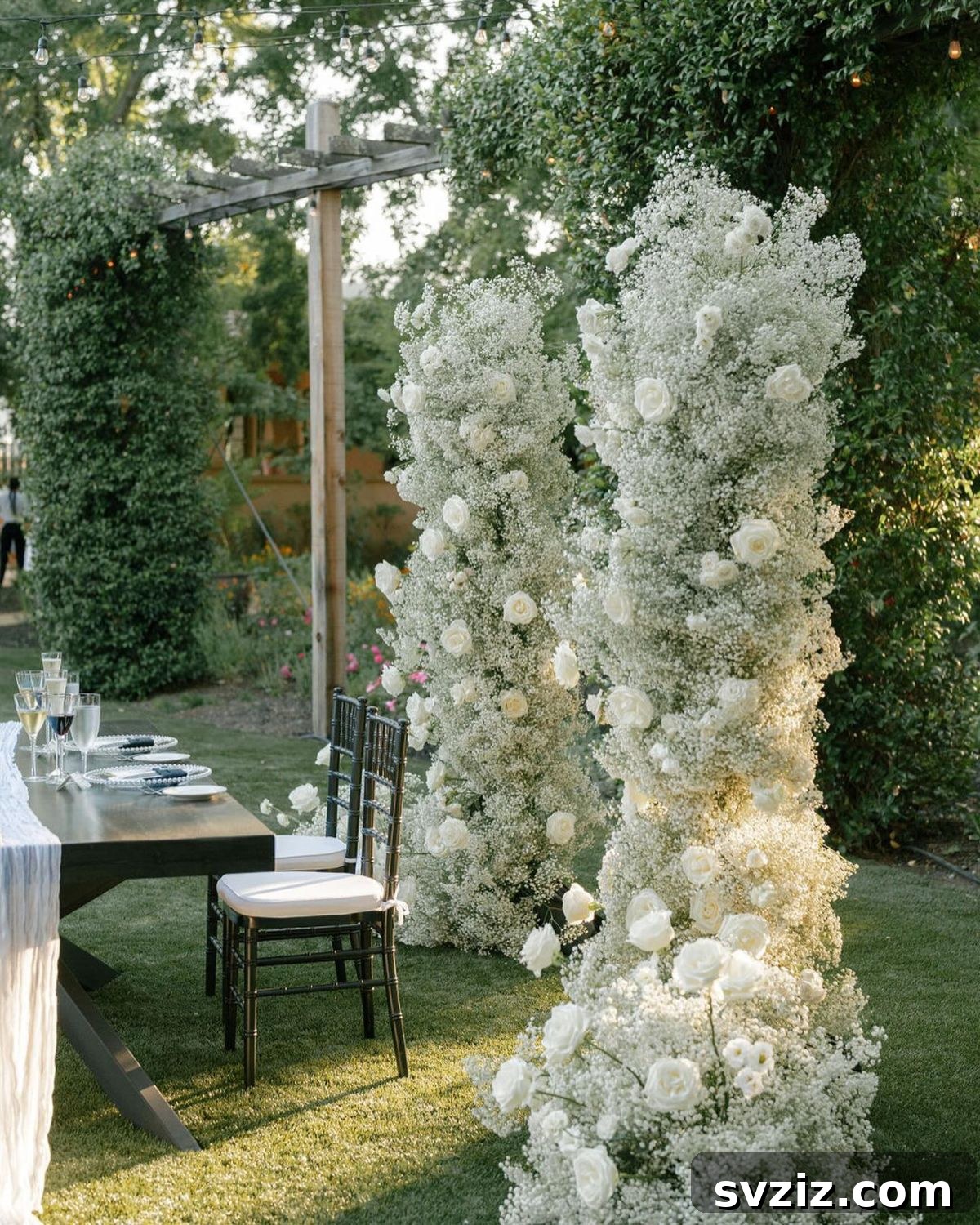 Stunning wedding ceremony arch adorned with delicate baby's breath and elegant white roses, perfect for a graceful backdrop.