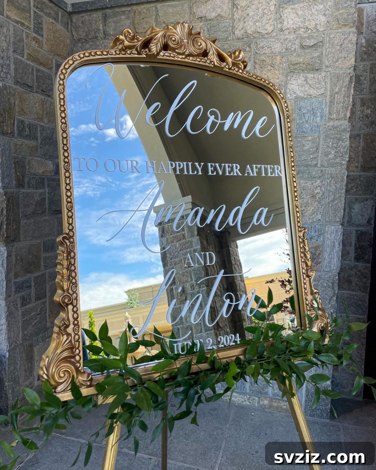 Ornate classic gold mirror welcome signage, adding Baroque elegance to a wedding entrance.