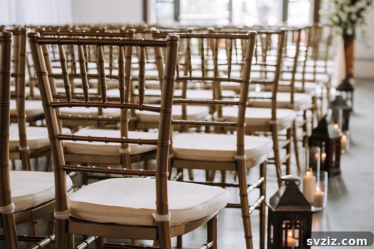 Rustic elegant wedding decor featuring open-back wooden chairs and antique-style farmhouse lamps with pillar candles.