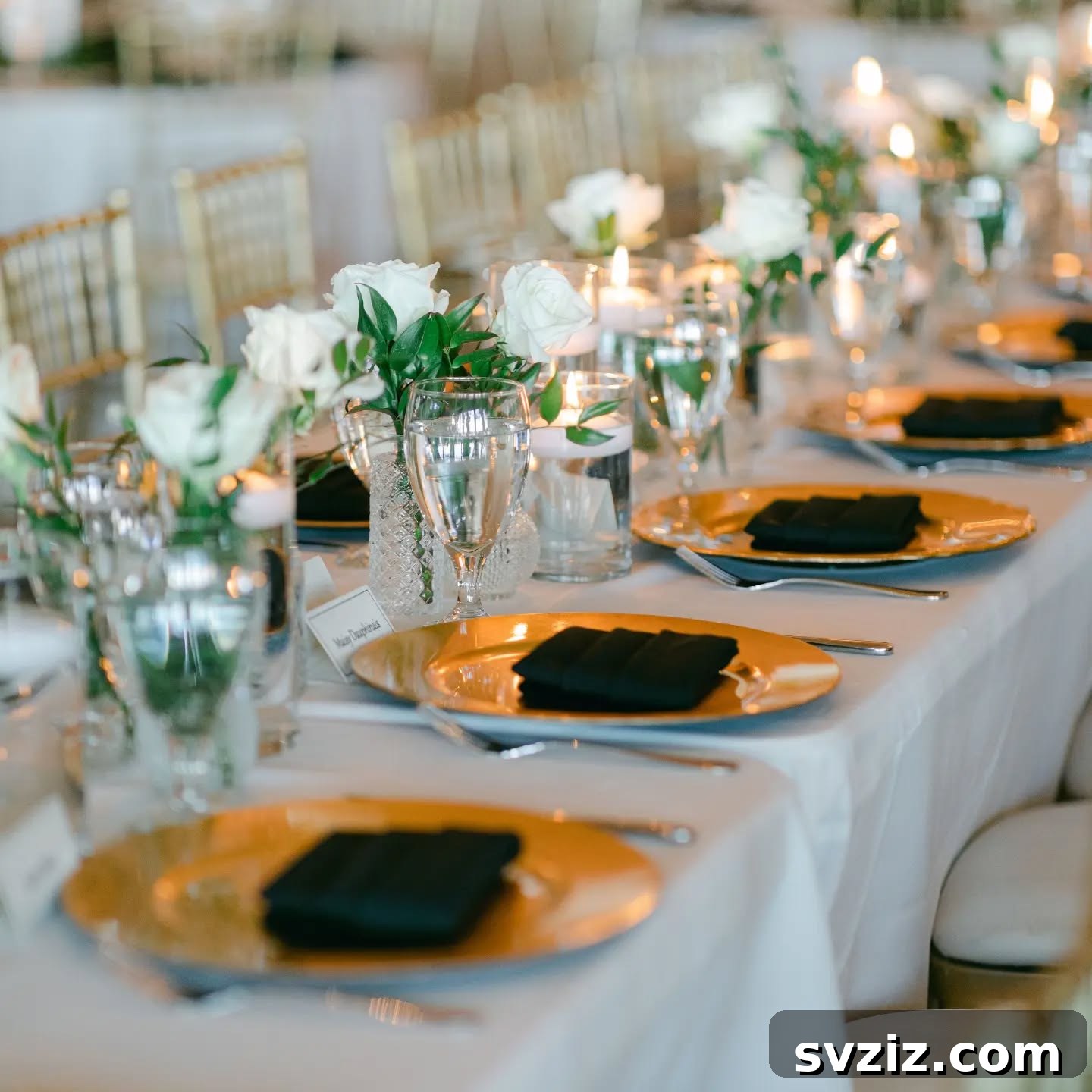 Opulent gold and black wedding reception decor with dramatic lighting, perfect for an evening classic wedding.