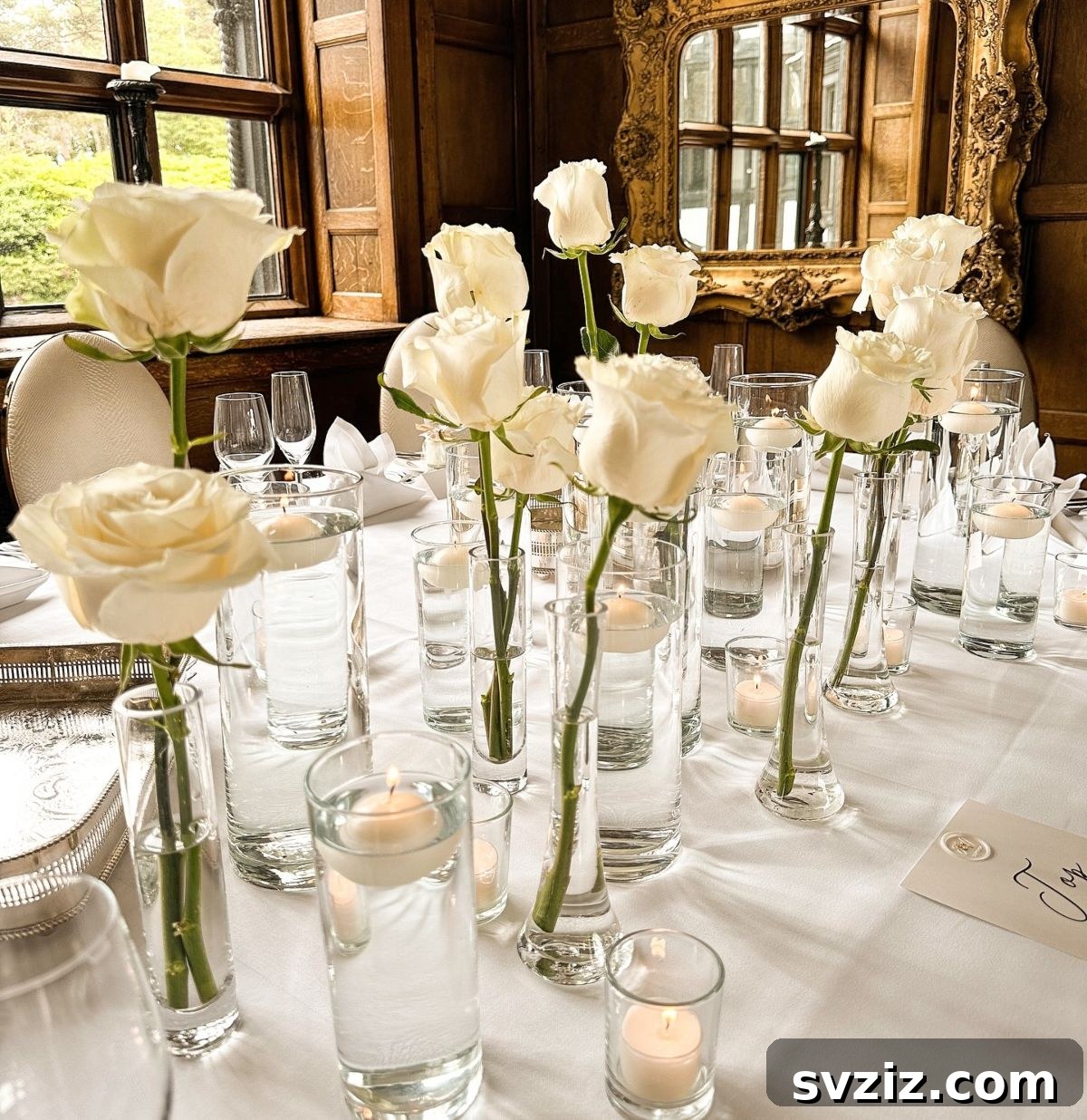 Magnificent wedding tablescape adorned with countless white roses and flickering candlelight for an unforgettable ambiance.
