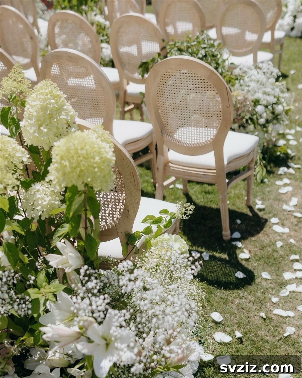 Charming garden wedding ceremony setup with elegant rattan lattice-back chairs amidst blooming flowers.