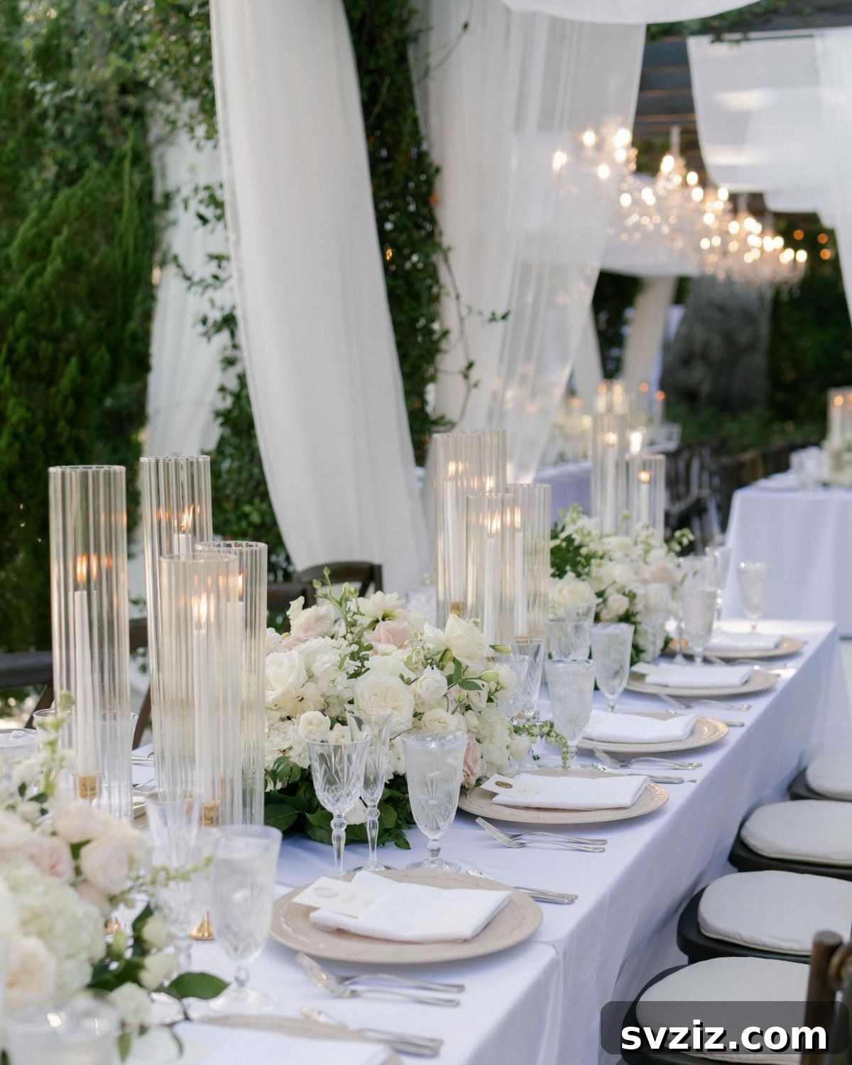 Enchanting wedding venue decorated with soft, floating white silk drapes and ambient lighting.