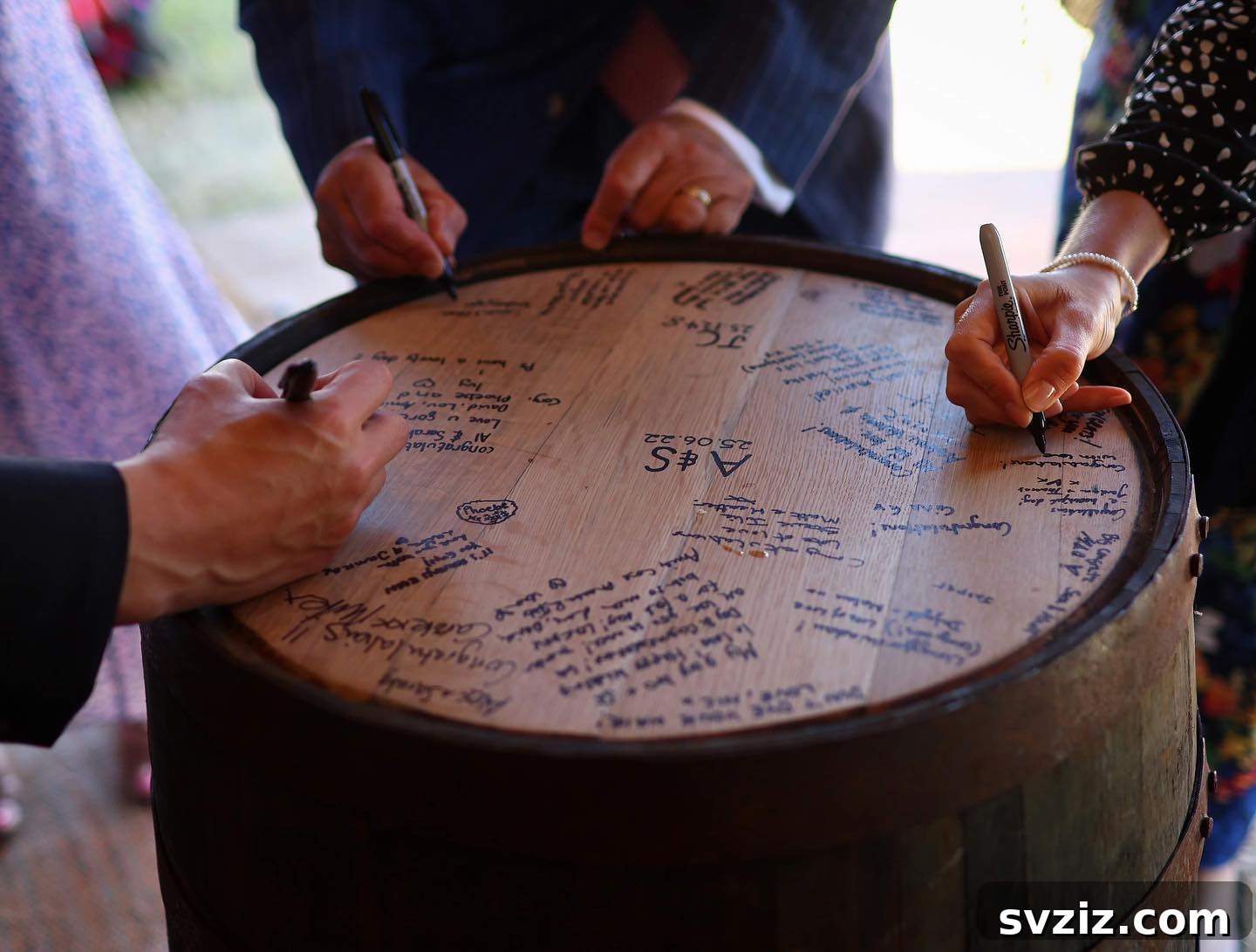 23 Ingenious Wedding Guest Signature Ideas 6 Rustic wine barrel used as a wedding guest book, with signatures on the wooden top.