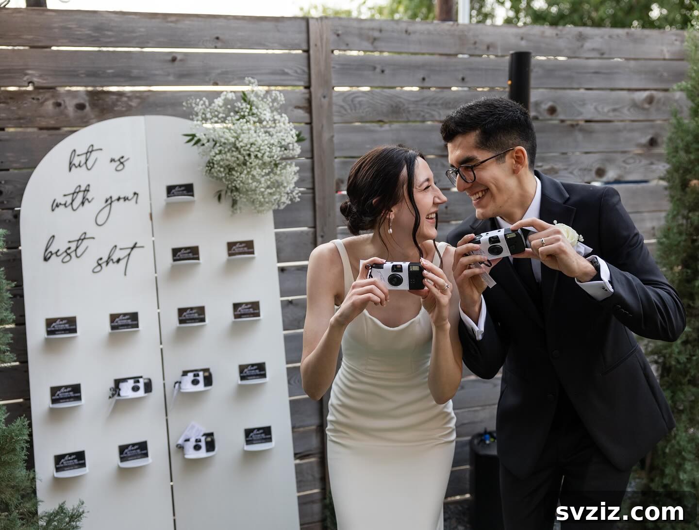 Wedding photo display inviting guests to contribute their best shots