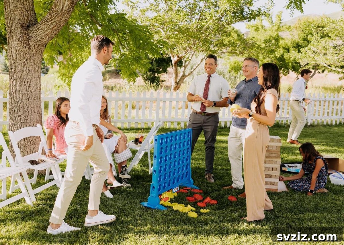 Guests playing giant Jenga and other yard games at an outdoor wedding reception