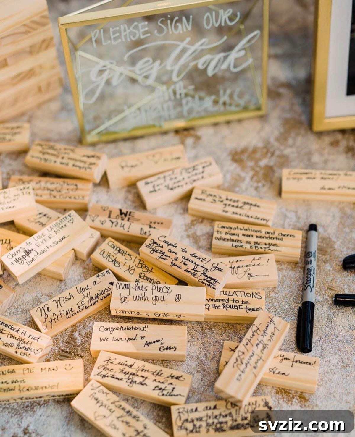 Wedding guests writing messages on Jenga blocks for a guest book alternative