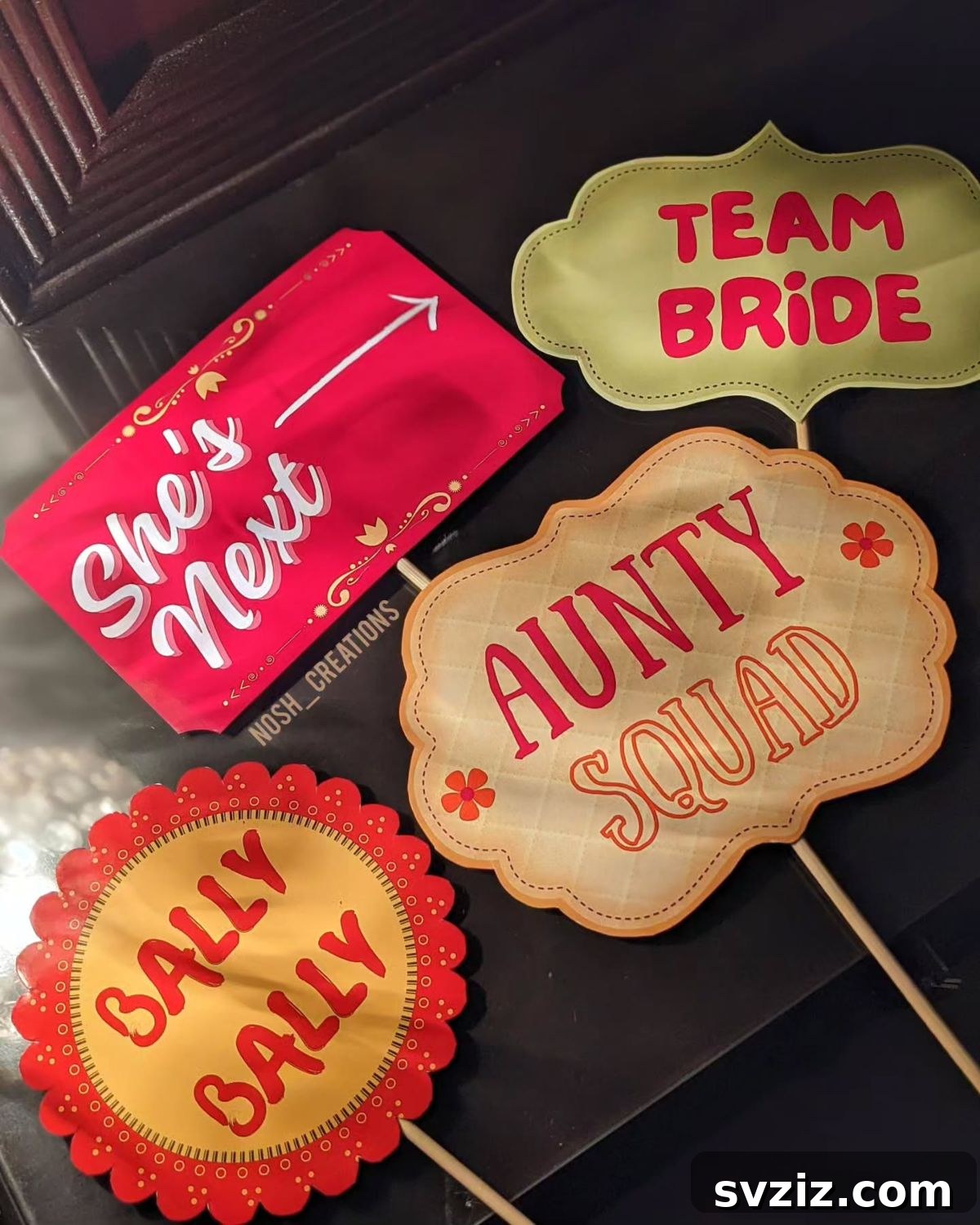 Wedding guests posing with vibrant photo booth props