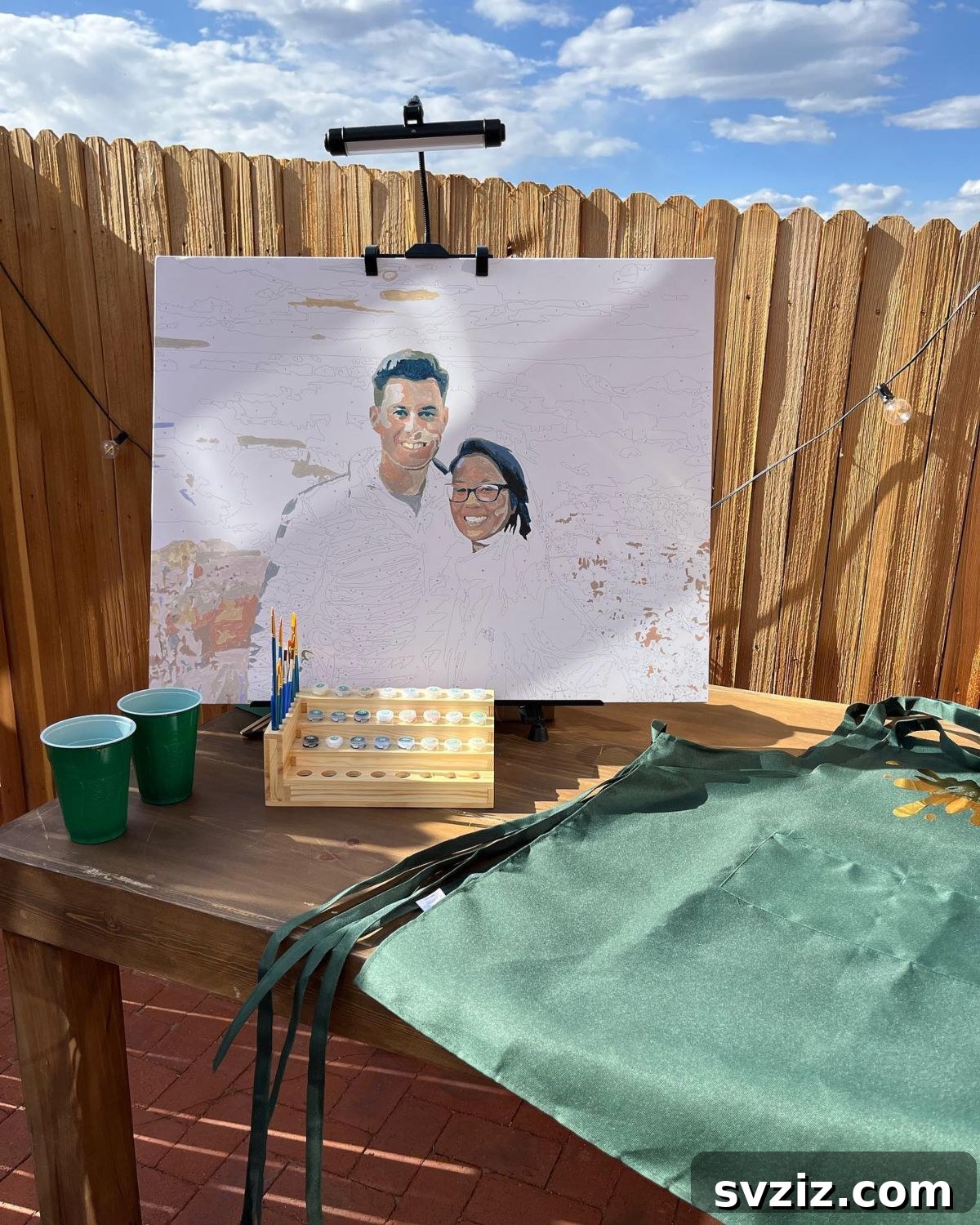 Wedding guests contributing to a paint-by-number portrait of the bride and groom