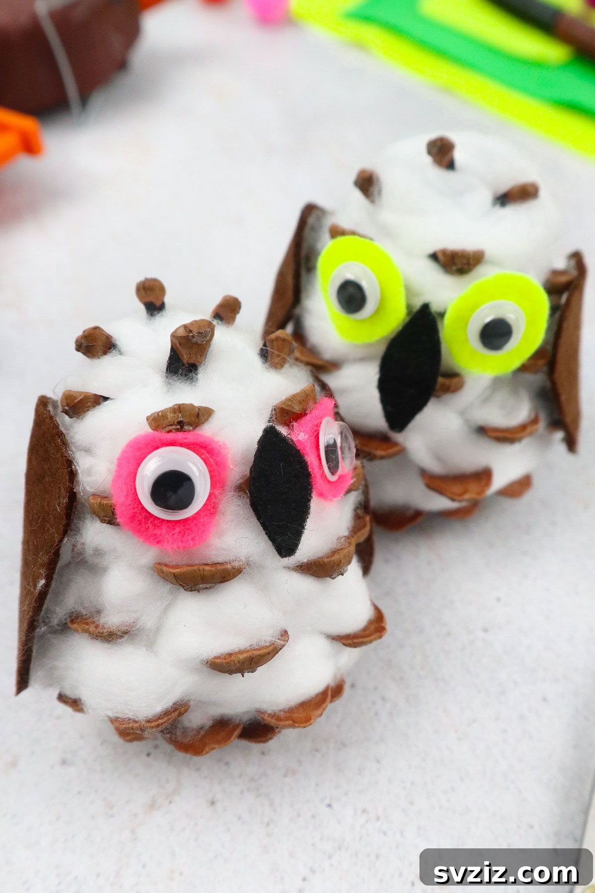 31 Effortless Kids Crafts for Hours of Fun 19 Charming Snowy Owl Craft made from pinecones and cotton balls, perfect for rustic winter seasonal decor.