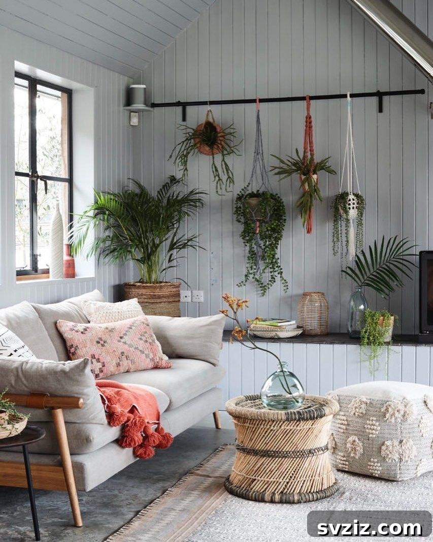 Cozy Corner Hideaway with cool gray tones, green plants, and a vibrant red throw.