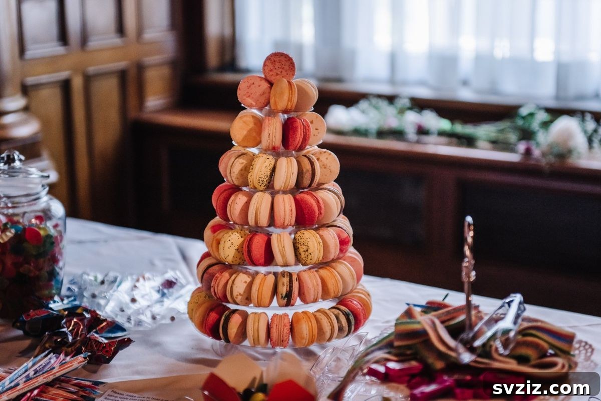 Exquisite Wedding Dessert Spreads 12 An elegant acrylic macaron tower stand showcasing numerous macarons, creating a marvelous and modern dessert display for a wedding.