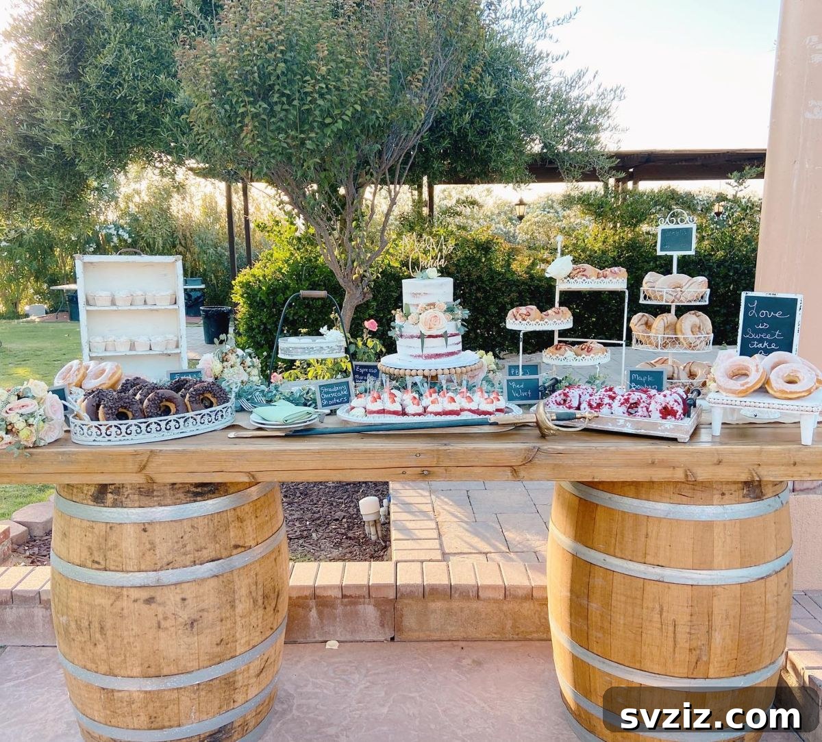 Exquisite Wedding Dessert Spreads 16 A stunning outdoor vintage-inspired dessert table, beautifully set with rustic barrels, wooden planks, and an abundance of donuts and cupcakes.