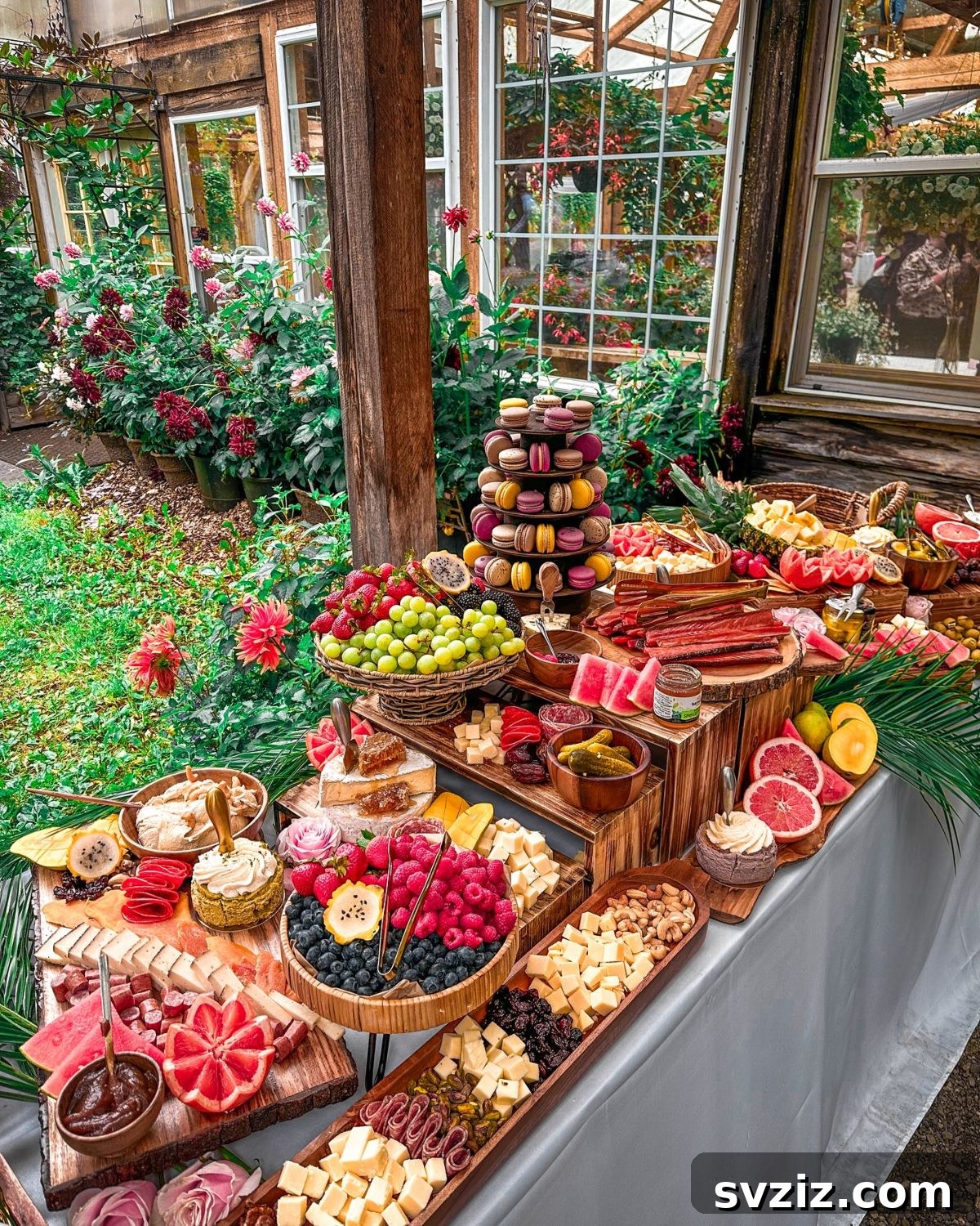 Exquisite Wedding Dessert Spreads 17 A vibrant and healthy wedding dessert table featuring juicy seasonal fruits, fresh berries, and rustic charcuterie boards with cheeses and crisp biscuits.