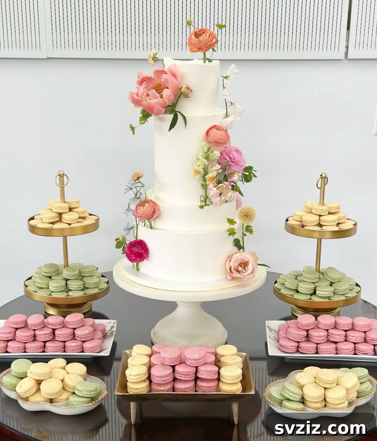 Exquisite Wedding Dessert Spreads 3 A stunning display of pastel-colored macarons arranged elegantly on a dessert table, perfect for adding soft, romantic charm to a wedding.