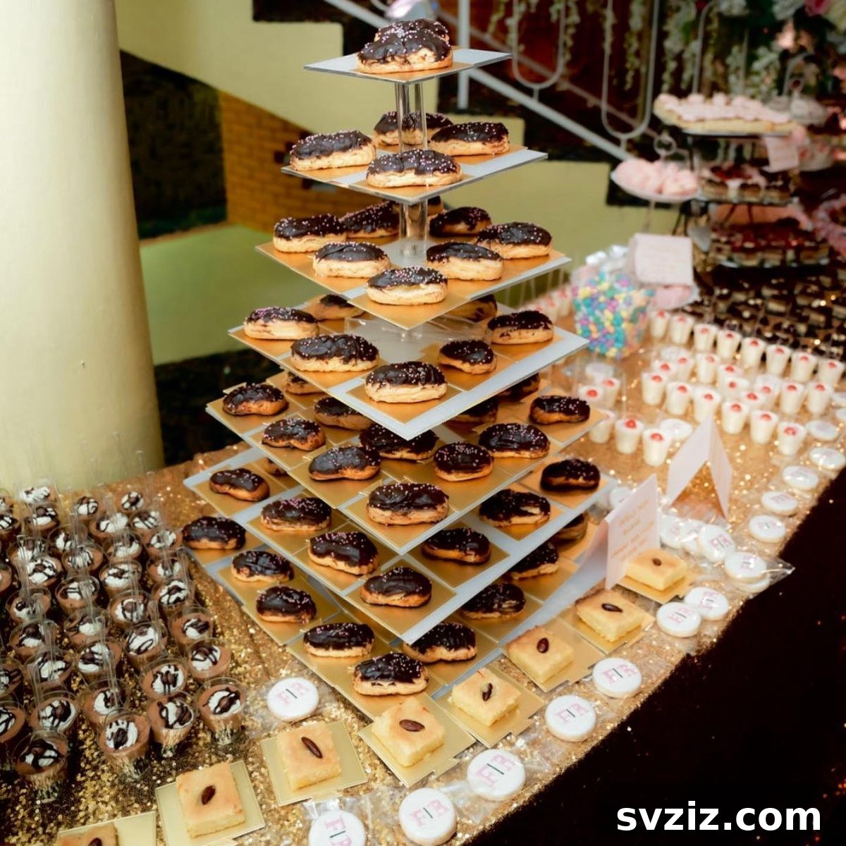Exquisite Wedding Dessert Spreads 22 An extravagant dessert table showcasing 'Layers of Eclair Love' with a wide variety of pastries including eclairs, opera cake, mousse shooters, and more.