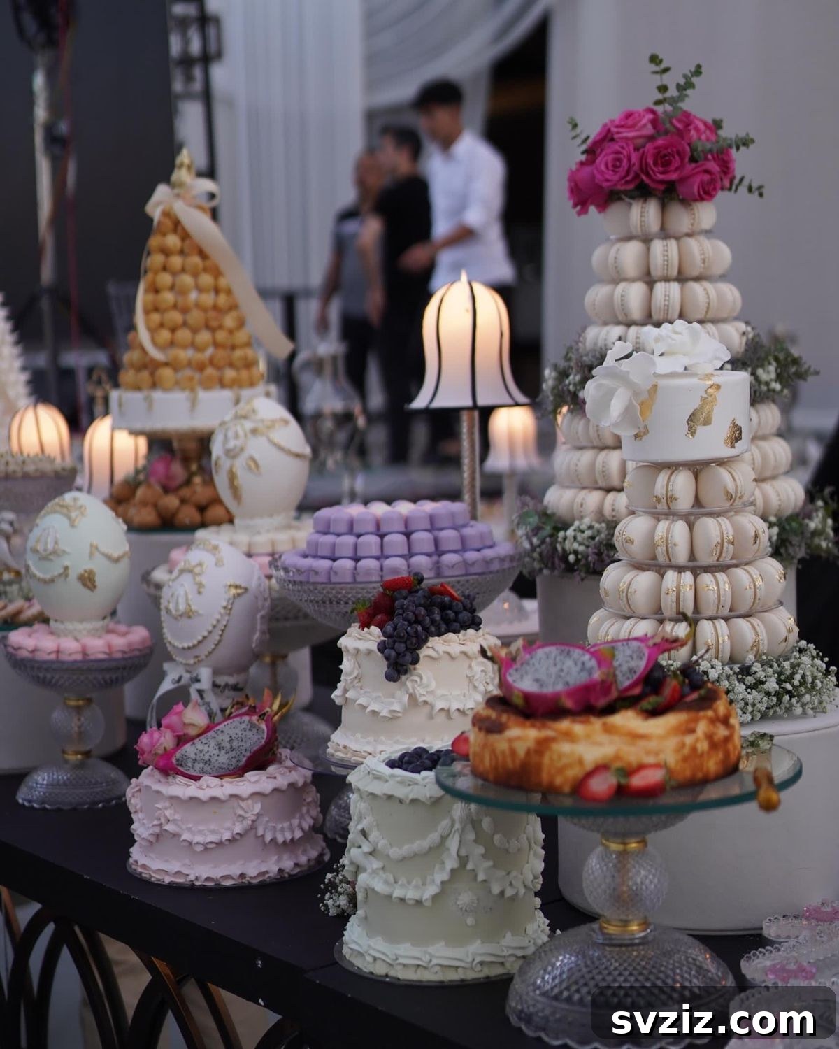 Exquisite Wedding Dessert Spreads 26 A luxuriously elegant 'Sweet Luxe Fantasy' dessert table, featuring ivory macaron towers, ornate gold-accented eggs, a croquembouche, and delicately piped cakes.