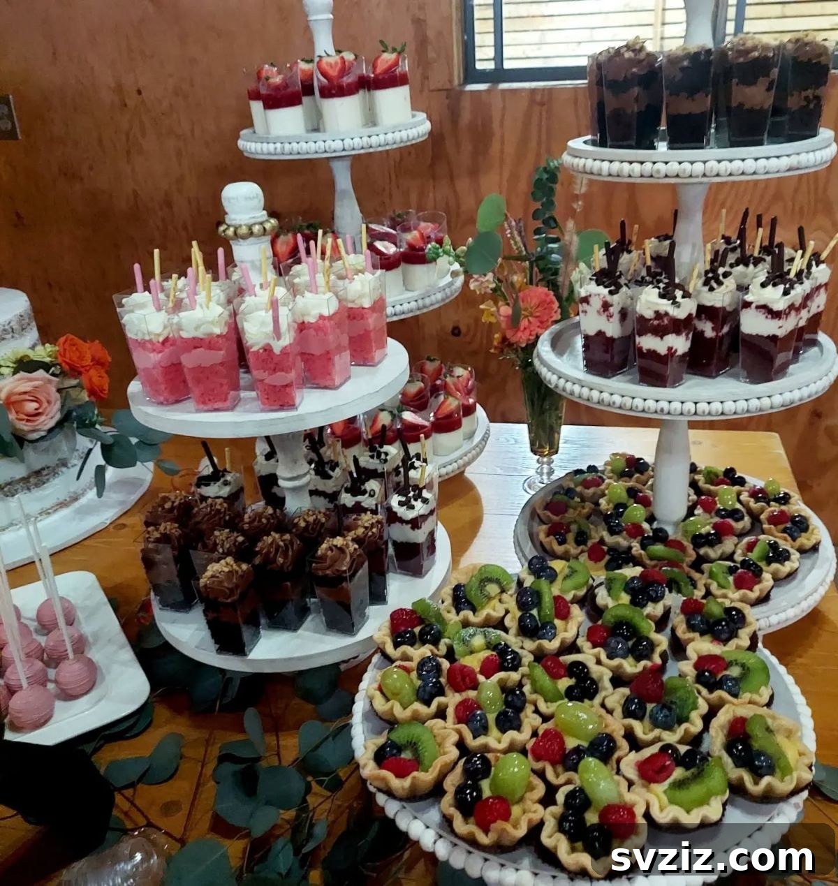 Exquisite Wedding Dessert Spreads 4 A vibrant display of layered dessert shooters, individually portioned mini desserts served in small glasses, perfect for a wedding dessert table.