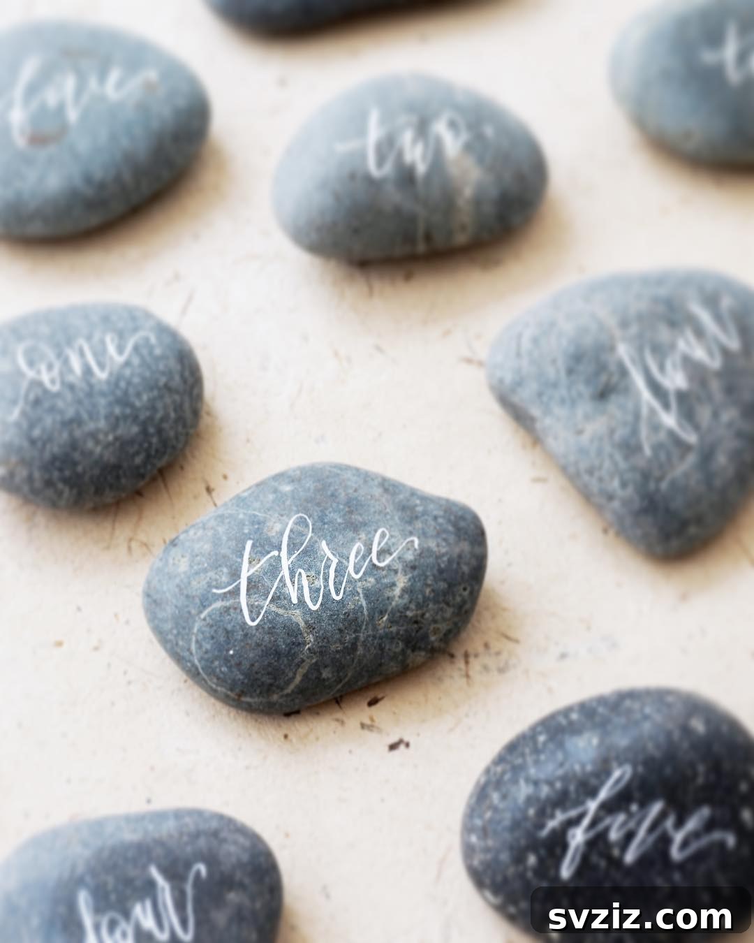 Calligraphy on Wishing Stones as Beach Wedding Table Numbers