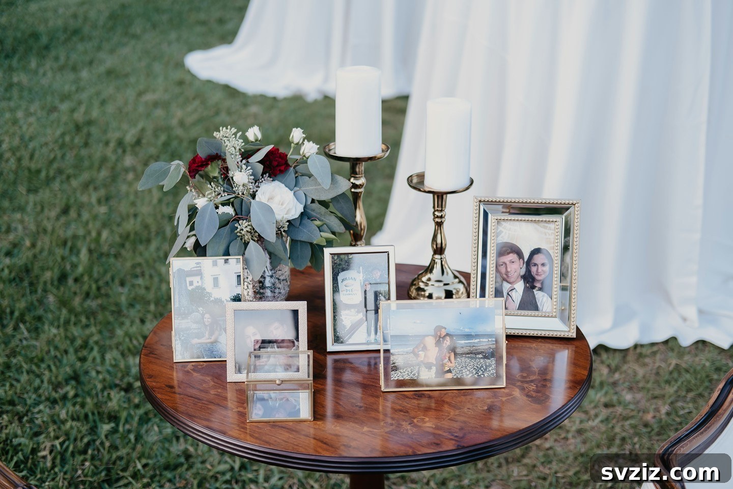Small round accent table used as a wedding memory display with a few framed photos.