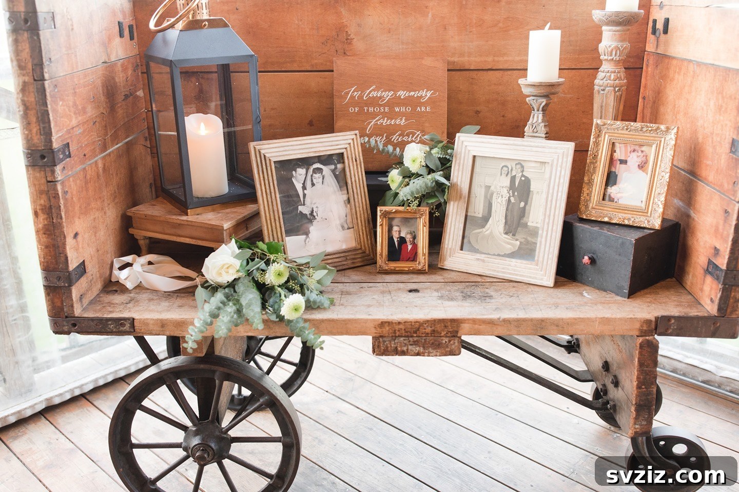 Vintage memory cart adorned with photos, flowers, and rustic decor for a wedding.