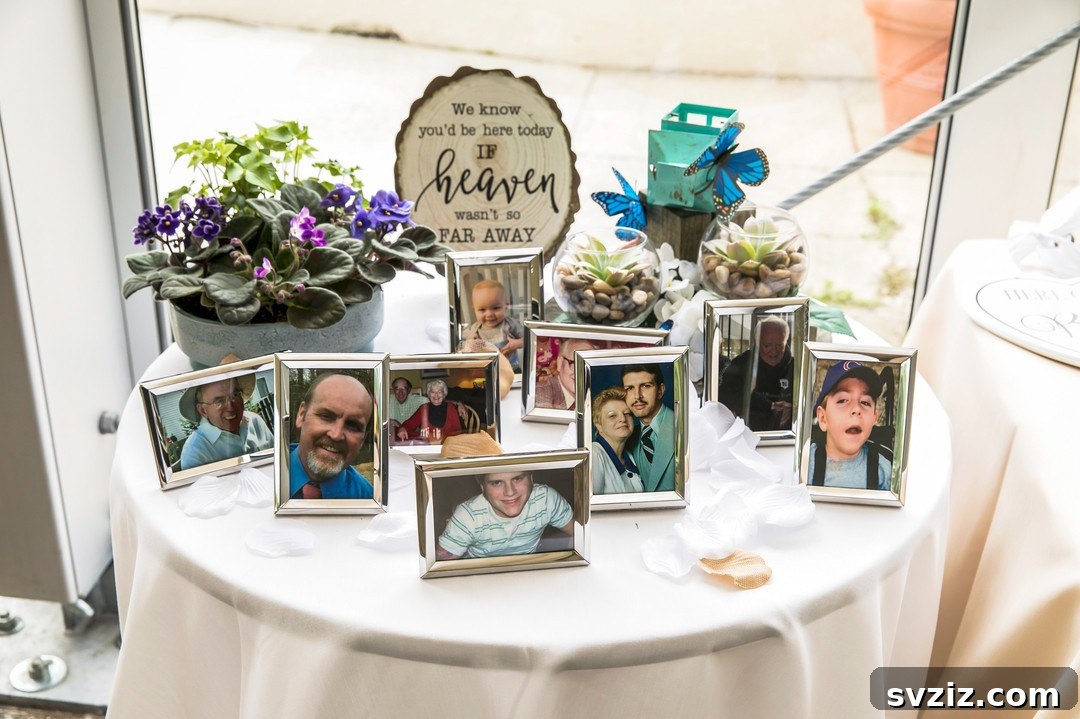 Wedding memory table decorated with framed photos and specific favorite flowers of honored loved ones.