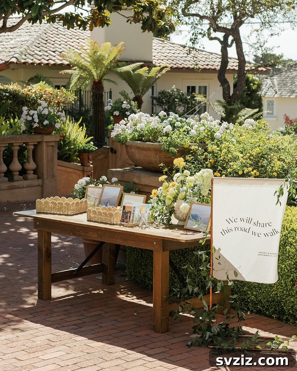Rustic welcome table adorned with photos, greenery, and charming details.