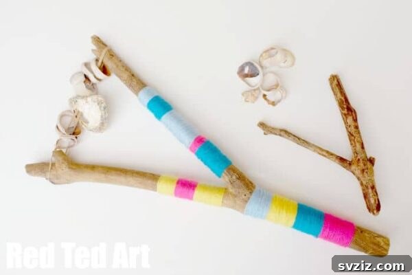 Unique beach rattles crafted from hollowed driftwood and filled with small broken shell pieces, representing a creative nature craft.