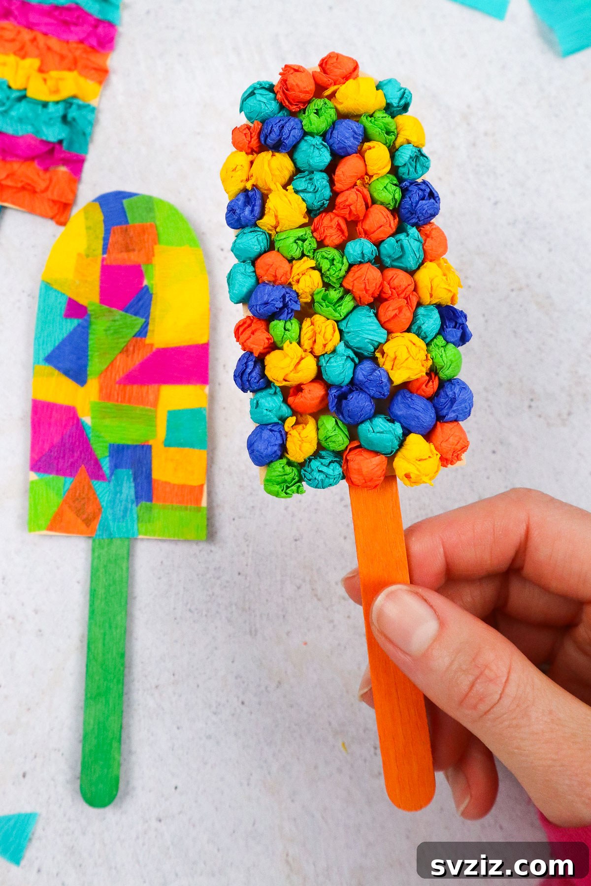 A colorful popsicle craft made with vibrant tissue paper, perfect for kids to create a fun beach-themed decoration.