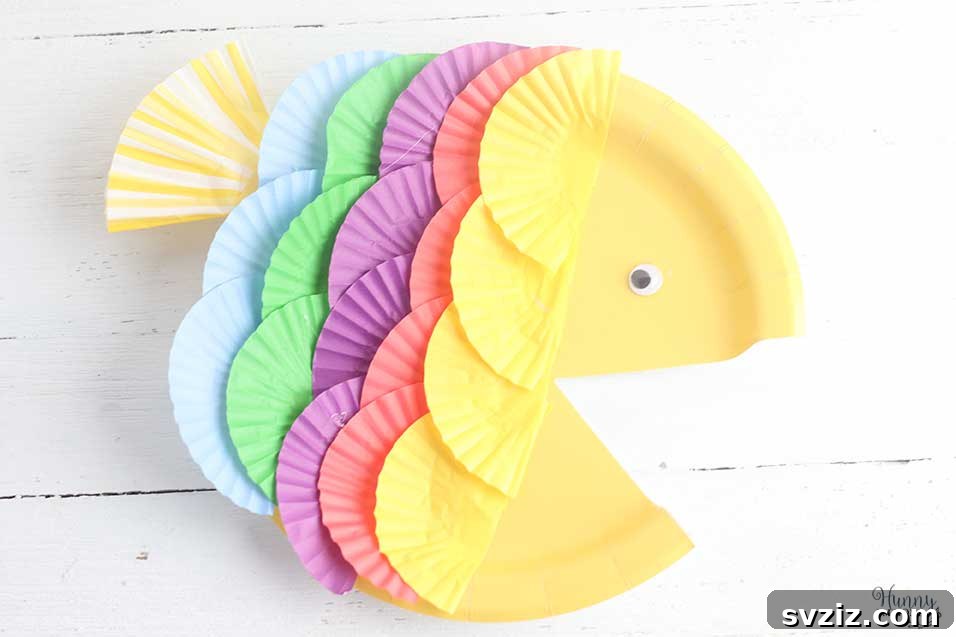 A sweet and colorful paper plate fish craft, reminiscent of Rainbow Fish, perfect for preschoolers.