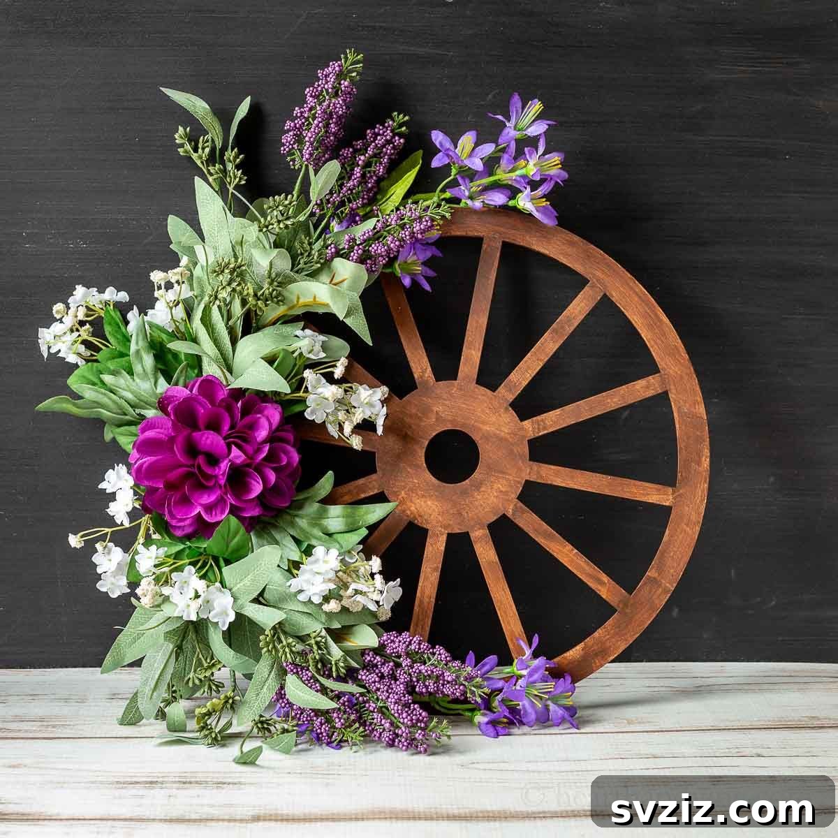 Creative Summer Projects for Grown-Ups 11 Charming wagon wheel wreath combining farmhouse aesthetics with beautiful summer florals.