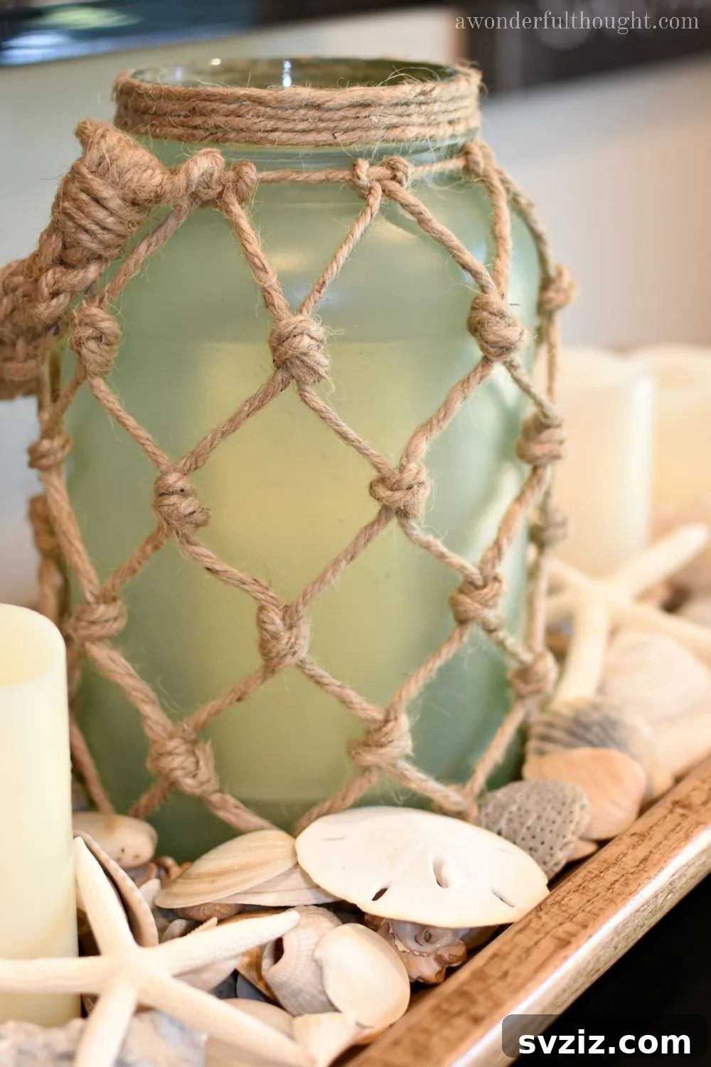 Creative Summer Projects for Grown-Ups 21 Coastal-inspired DIY sea glass rope lantern made from a glass jar and jute rope.