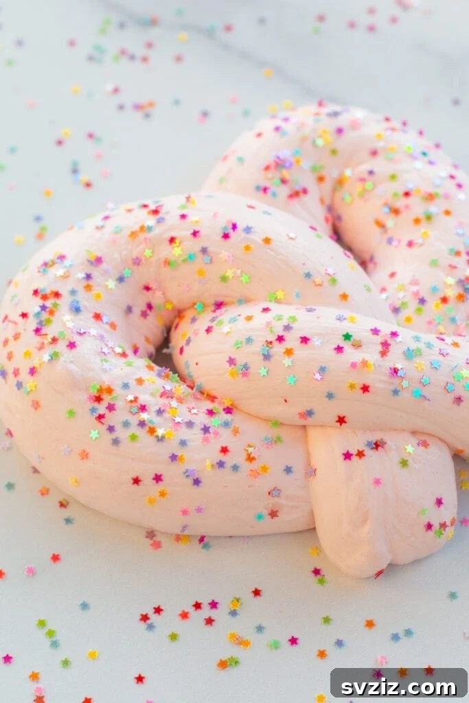 Child stretching a vibrant, soft, and fluffy slime.