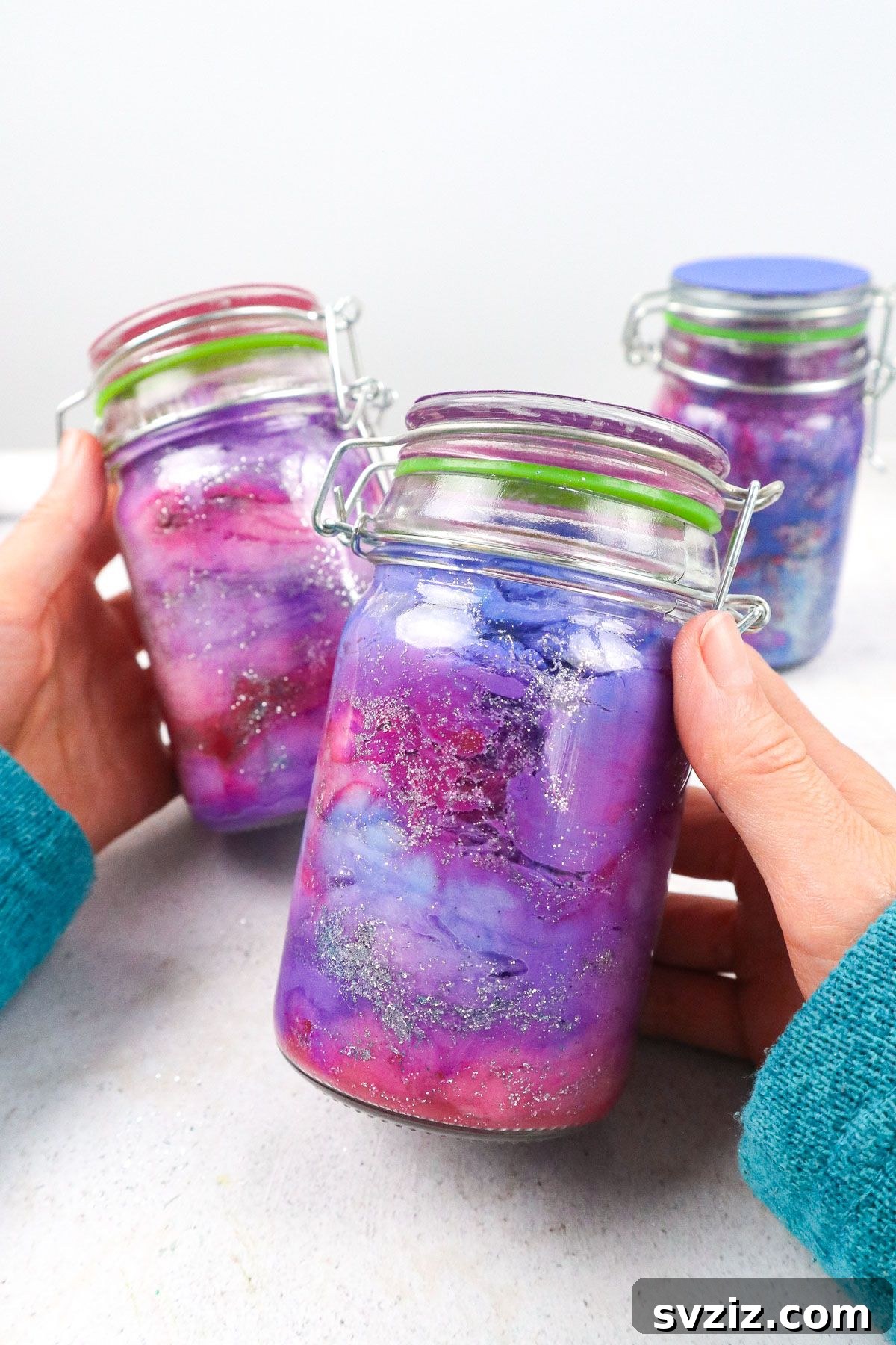 Handmade DIY Galaxy Jar with swirling colors and glitter.