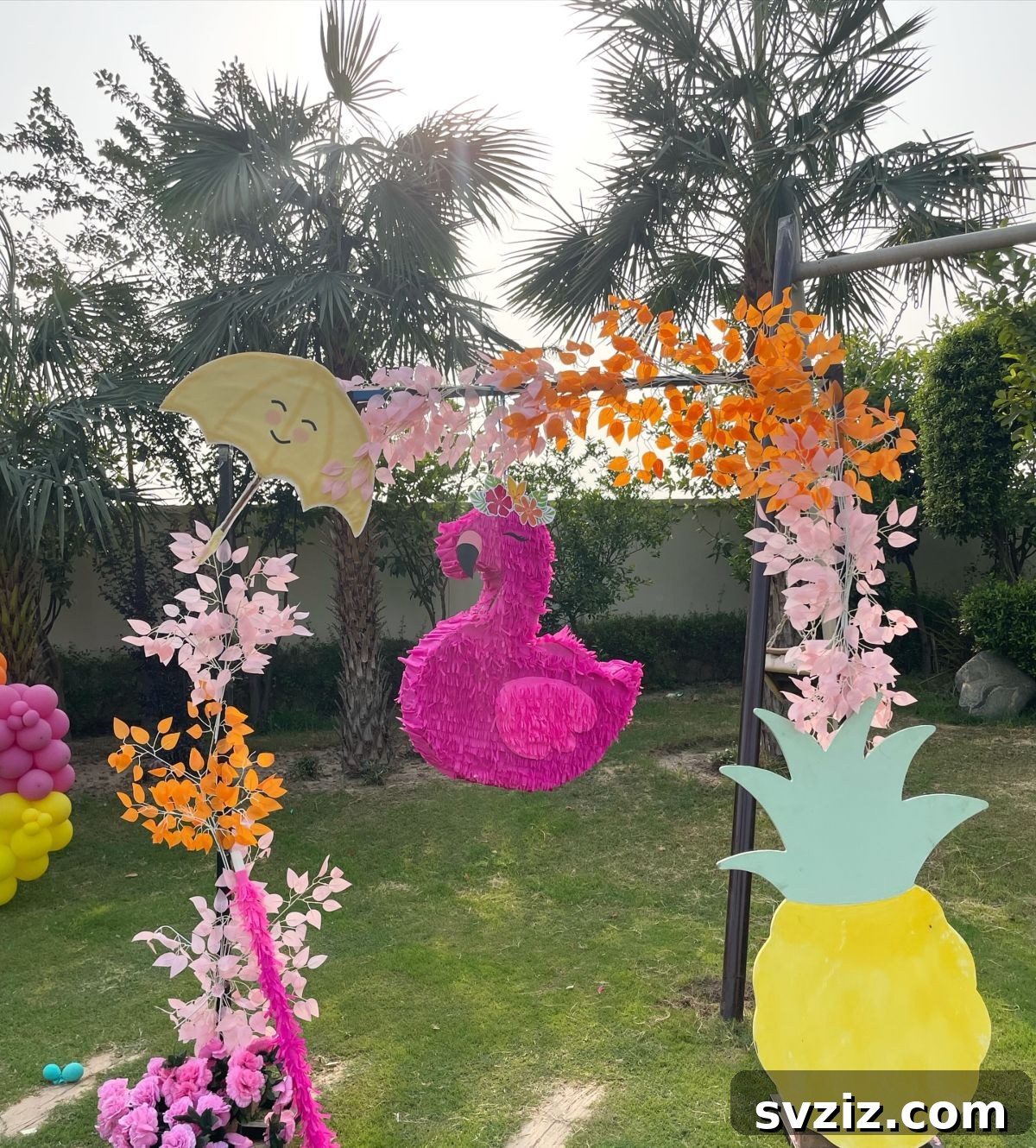 Splash into Summer: Creative Pool Party Ideas 13 Decorative pool party arch with tropical florals and flamingo decor.
