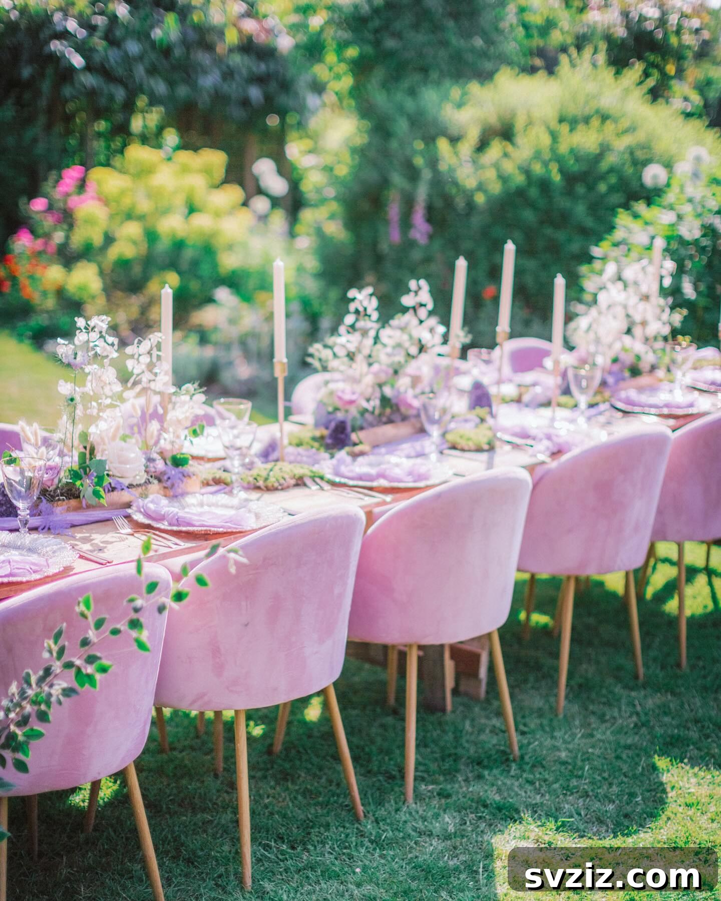 Stunning Summer Wedding Color Palettes 28 Princess-worthy tablescape featuring soft pink and purple hues, gold candlesticks, and lush green surroundings