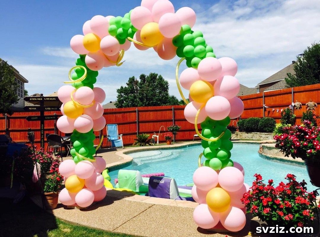 Soft pink, yellow, and green balloon arch, perfect for a gentle and elegant pool party.