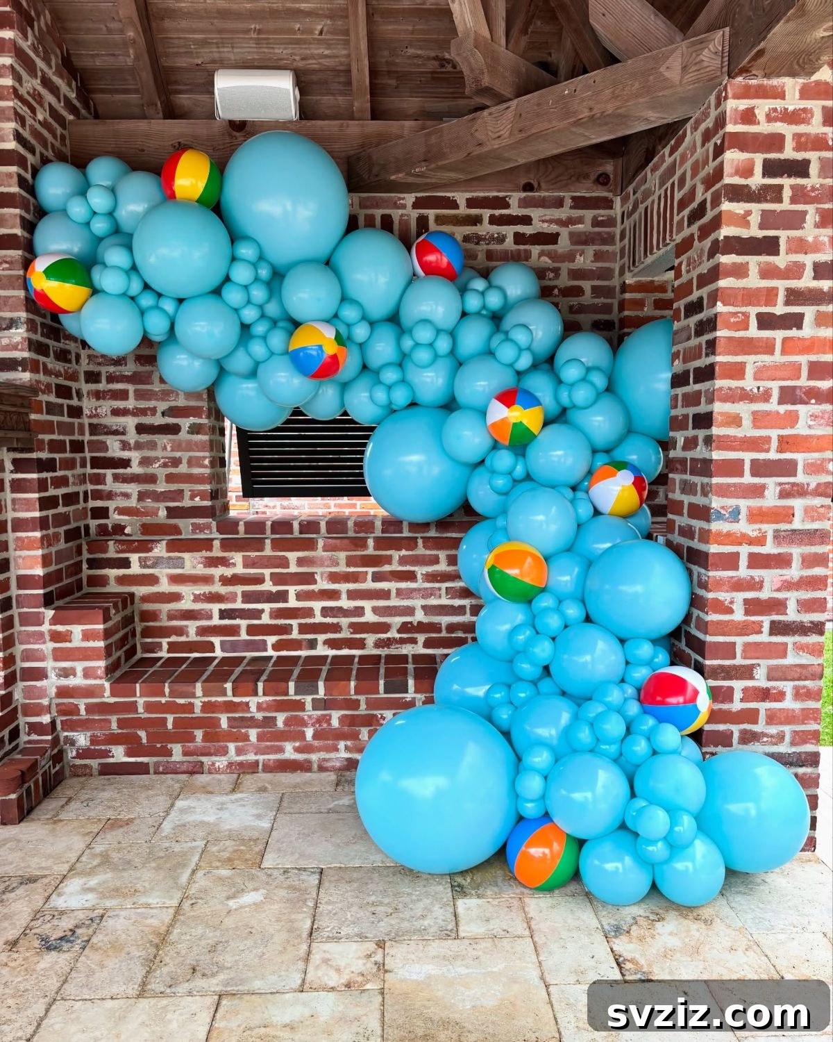 True blue balloon setup with cute mini beach balls interspersed, perfect for a playful pool party.