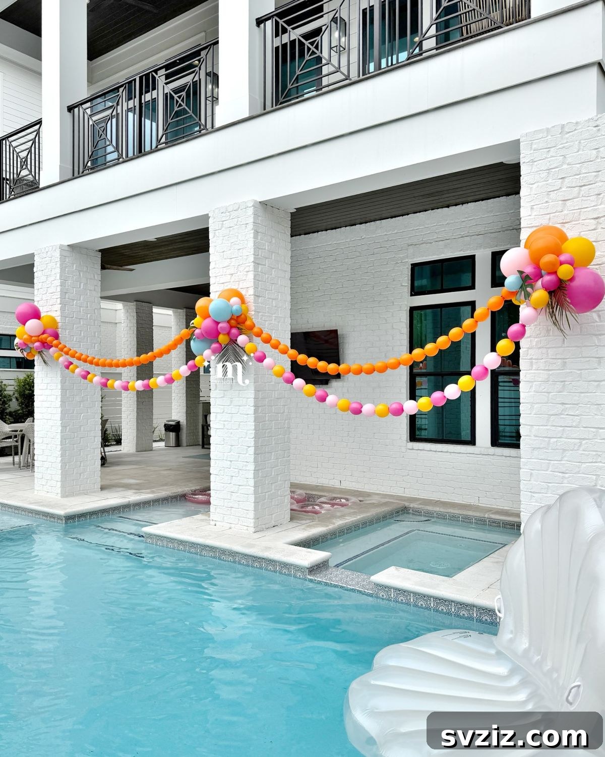 Gorgeous balloon beads and clusters in pink and orange for a vibrant pool party display.
