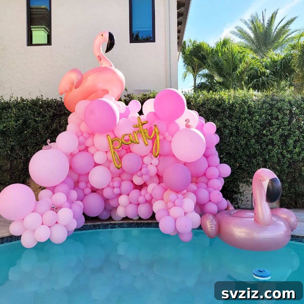 Flamingo themed pool party with pink balloons, floating flamingos, and gold 'party' letters.