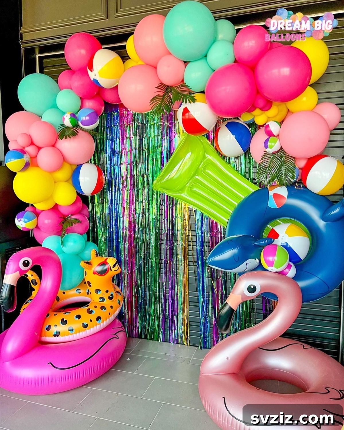 Pool party with inflatable flamingos and an arch of rainbow-colored balloons, creating a super festive vibe.