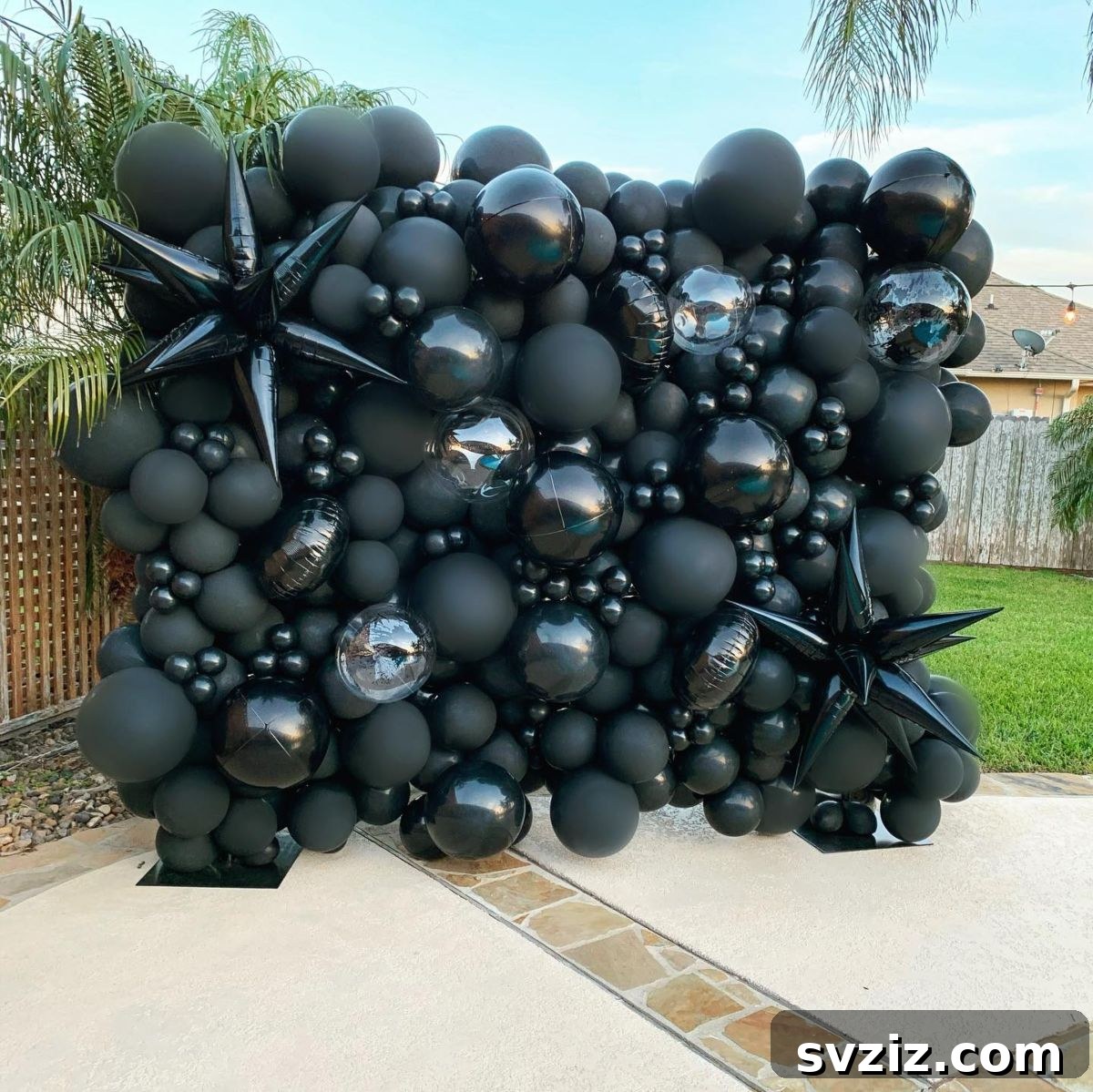 Elegant black balloon display for a chic and glamorous pool party setting.