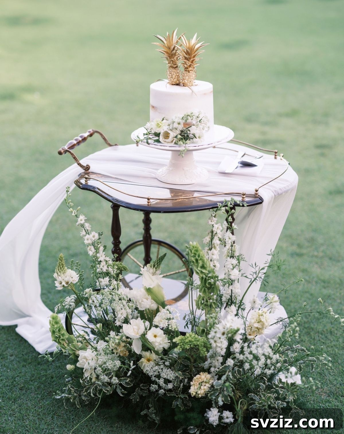 23 Dreamy Backyard Micro Wedding Concepts 13 Wedding cake displayed on a vintage cart in a garden setting