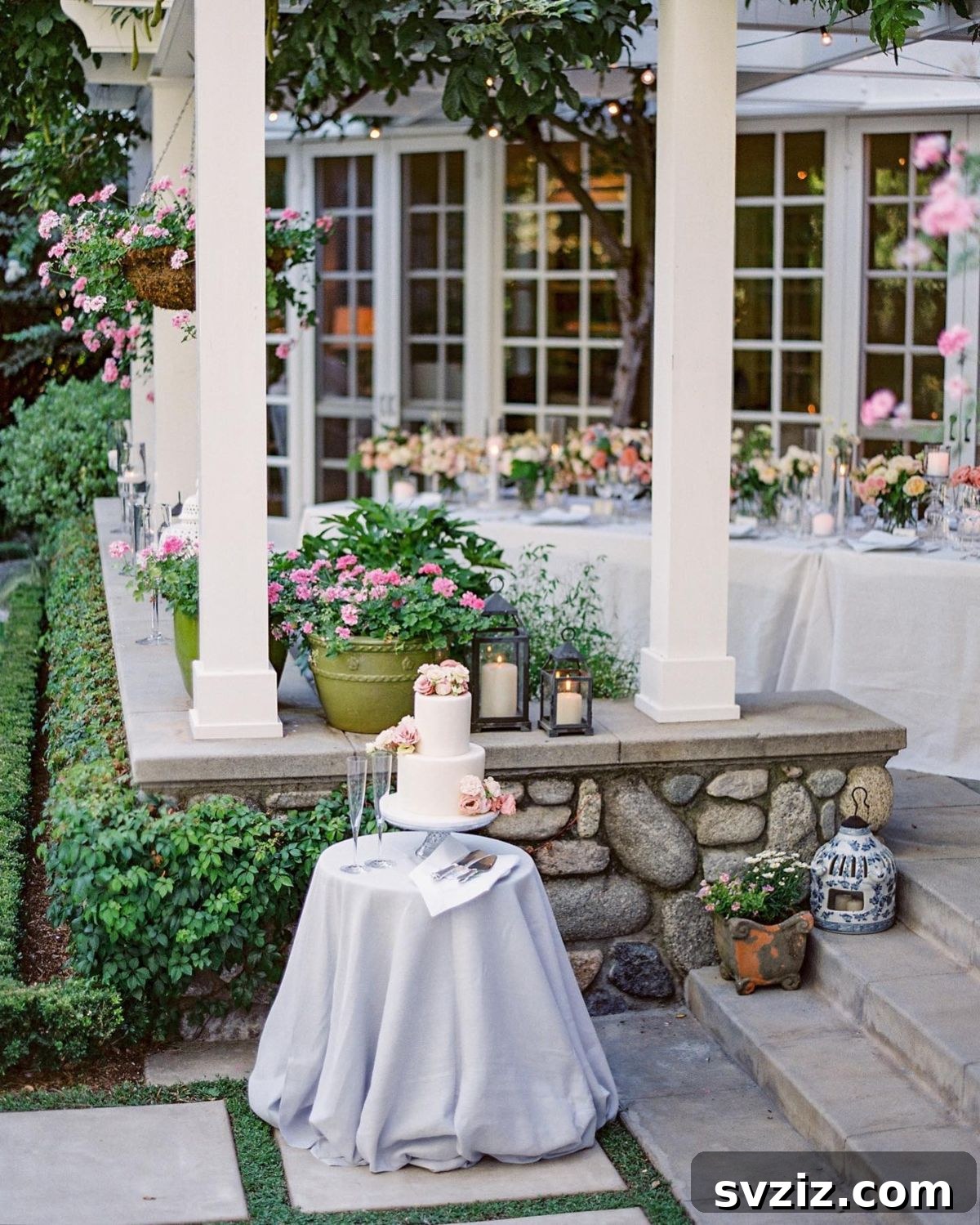 23 Dreamy Backyard Micro Wedding Concepts 17 Wedding cake table with floral decorations against a greenery backdrop