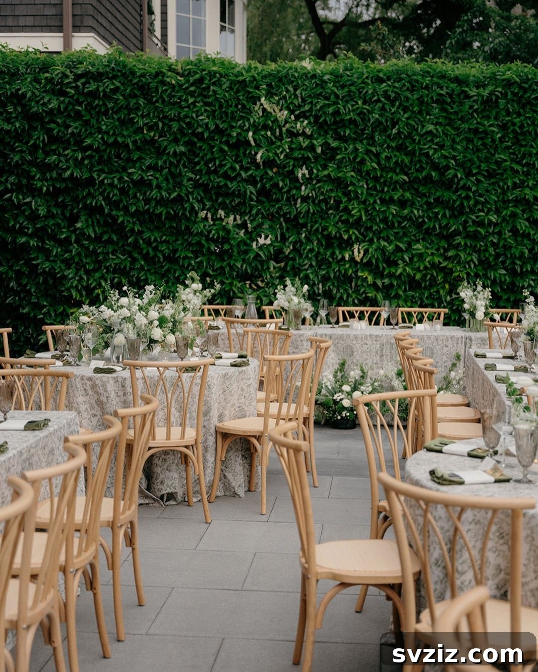 23 Dreamy Backyard Micro Wedding Concepts 19 Wedding tables set against a vibrant green hedge backdrop