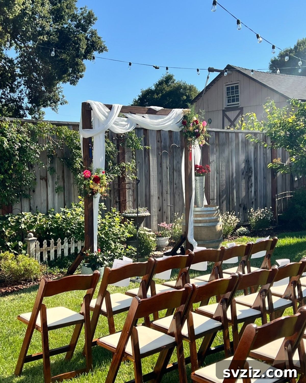 23 Dreamy Backyard Micro Wedding Concepts 3 Rustic wooden arch with elegant draping for an intimate backyard wedding
