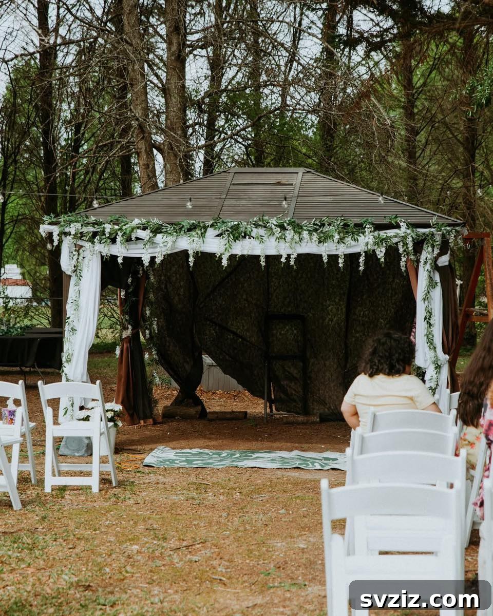 23 Dreamy Backyard Micro Wedding Concepts 21 Pergola decorated with white drapes and green garlands for a wedding ceremony