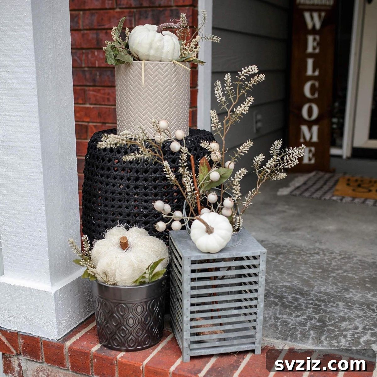 31 Autumn Outdoor Decor Ideas to Enhance Your Home's Curb Appeal 3 Chic Porch Pumpkin Decor featuring white pumpkins and elegant planters