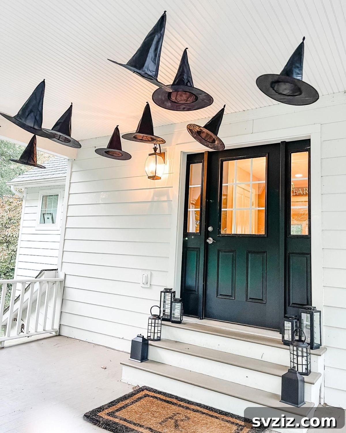 31 Autumn Outdoor Decor Ideas to Enhance Your Home's Curb Appeal 26 Spooky fall decor with hanging witch hats and elegant black lanterns