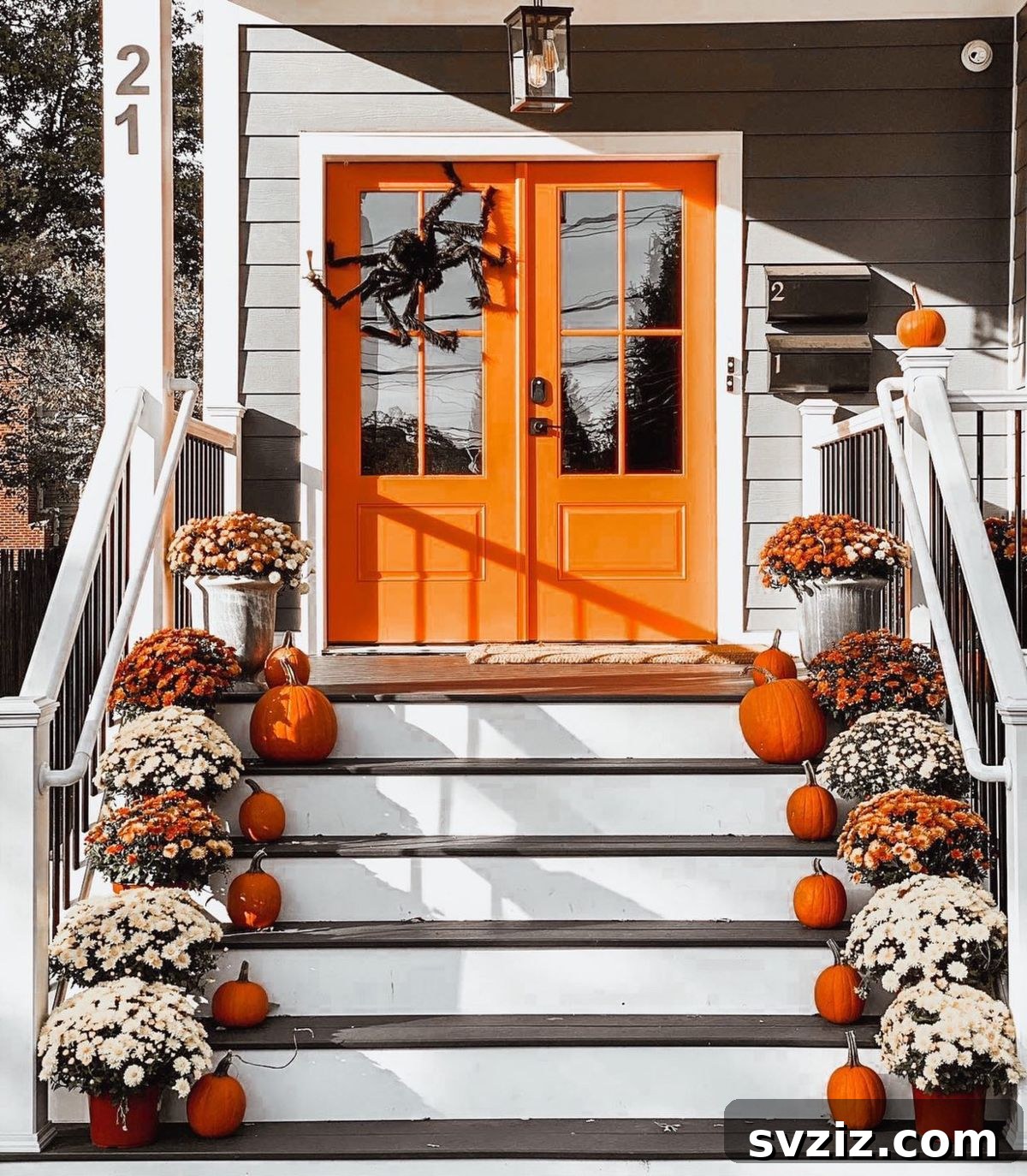 31 Autumn Outdoor Decor Ideas to Enhance Your Home's Curb Appeal 28 Spooky fall porch steps with gorgeous florals, pumpkins, and an oversized spider on the door